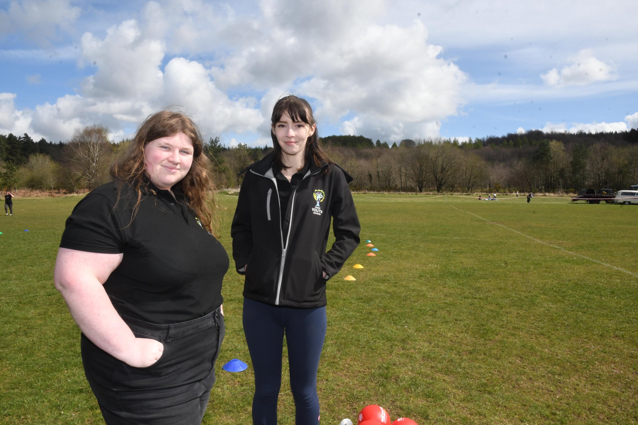 Eight-year-old Tyler Billett has a go at being a town crier with help from Ryan Morgan of Cinderford Town Council. Above right: Frederica Jones of Ruardean has a go on the swing set up by Cinderford Artspace .Right: Ilyana Watkins and Courtney Middleton from the Forest Youth Association were helping out with games on the field.