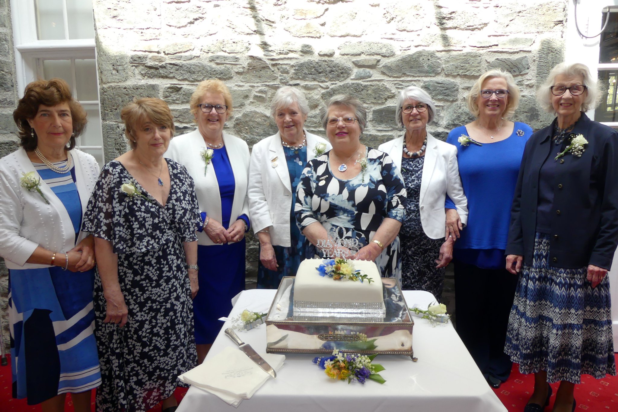 Tavistock Flower Club long-standing members Janet Norman and Nita Keast cutting the 60th birthday celebration cake surrounded by other members. RIGHT: National demonstrator Alison Penno: BELOW: Members enjoying the celebratory lunch.