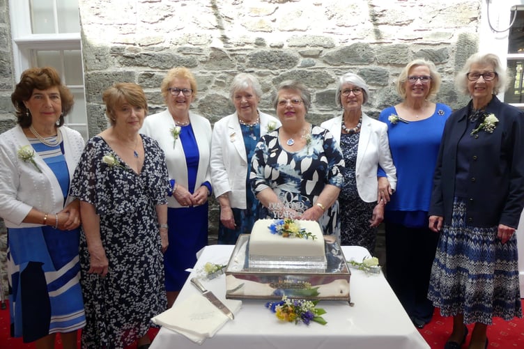 Tavistock Flower Club long-standing members Janet Norman and Nita Keast cutting the 60th birthday celebration cake surrounded by other members. RIGHT: National demonstrator Alison Penno: BELOW: Members enjoying the celebratory lunch.