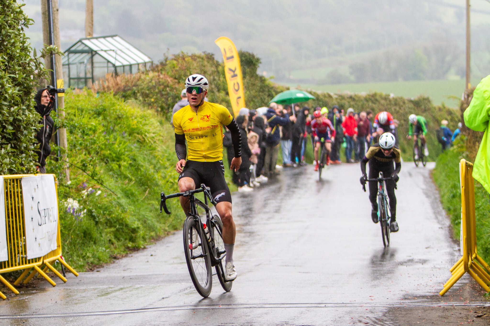 Noah Hobbs of Tekkerz CC winning the Ellerslie road race in wet conditions on Saturday afternoon from Utmost Isle of Man Junior Cycling Team member Zac Walker. Hobbs won the Junior Youth Tour overall with Walker third. The older riders were touching 50mph on the descent past Corvalley (Photos: Gary Jones/Manxman photos)