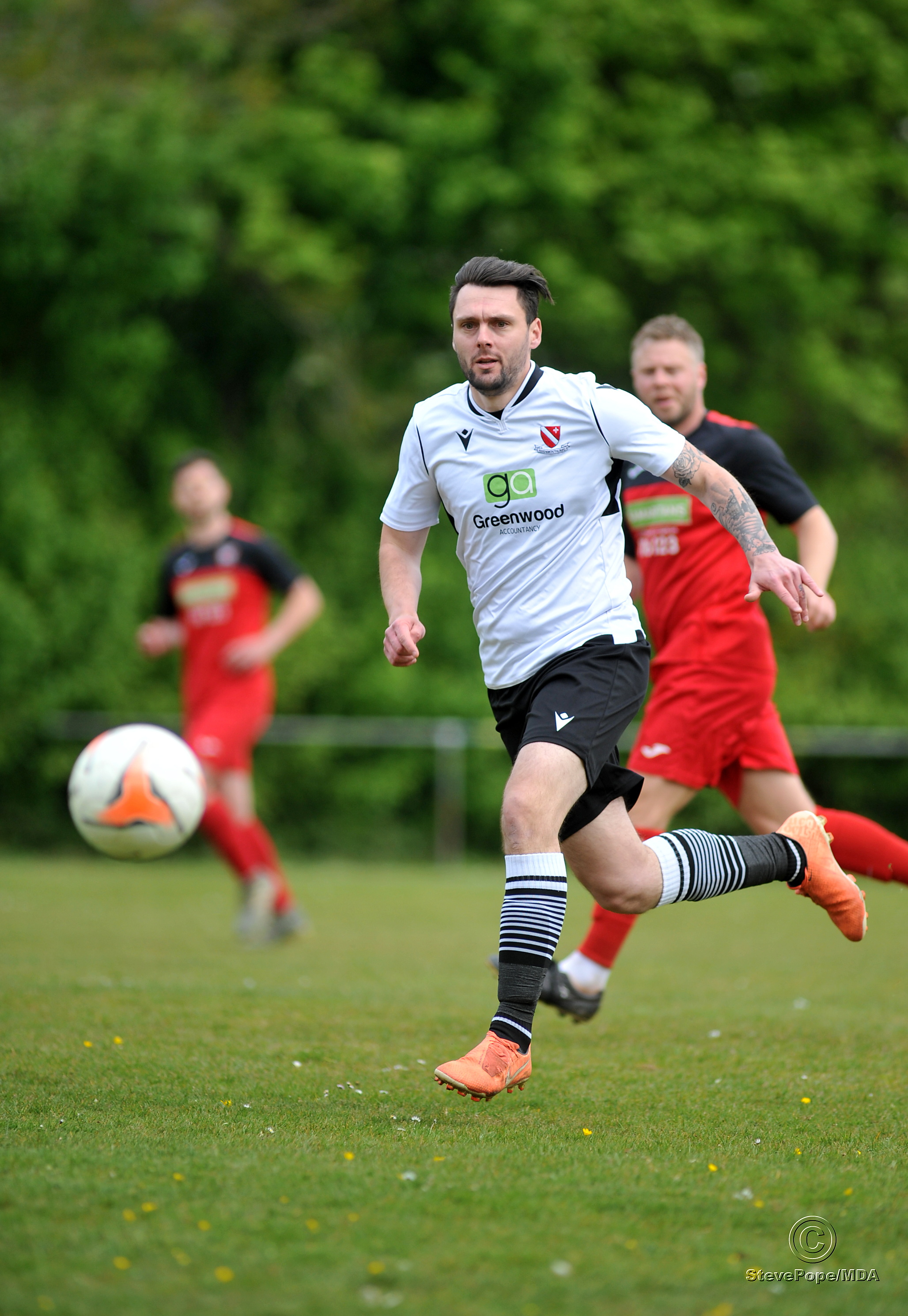 Action from Teignmouth’s clash with Plymstock United on Saturday – which saw the Teigns clinch the Devon Football League South & West title.