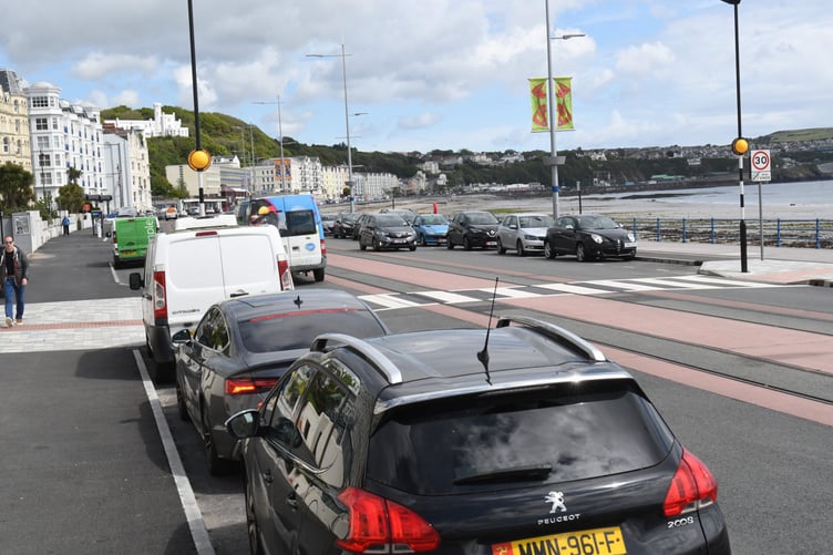 Parked cars adjoining a pedestrian crossing at the esplanade on Douglas Promenade -