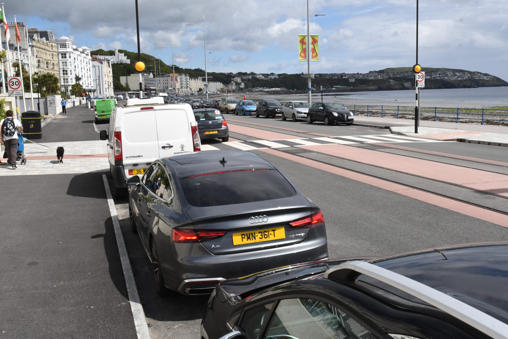 Parked cars adjoining a pedestrian crossing at the esplanade on Douglas Promenade -