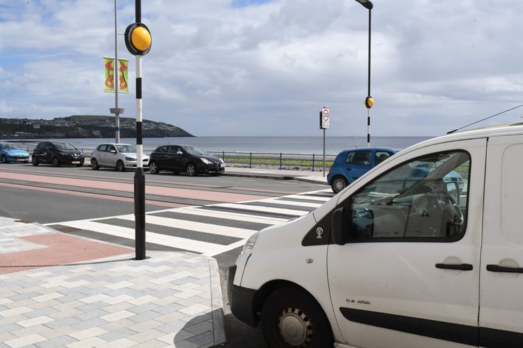 Parked cars adjoining a pedestrian crossing at the esplanade on Douglas Promenade -
