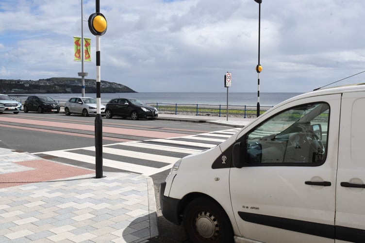 Parked cars adjoining a pedestrian crossing at the esplanade on Douglas Promenade -