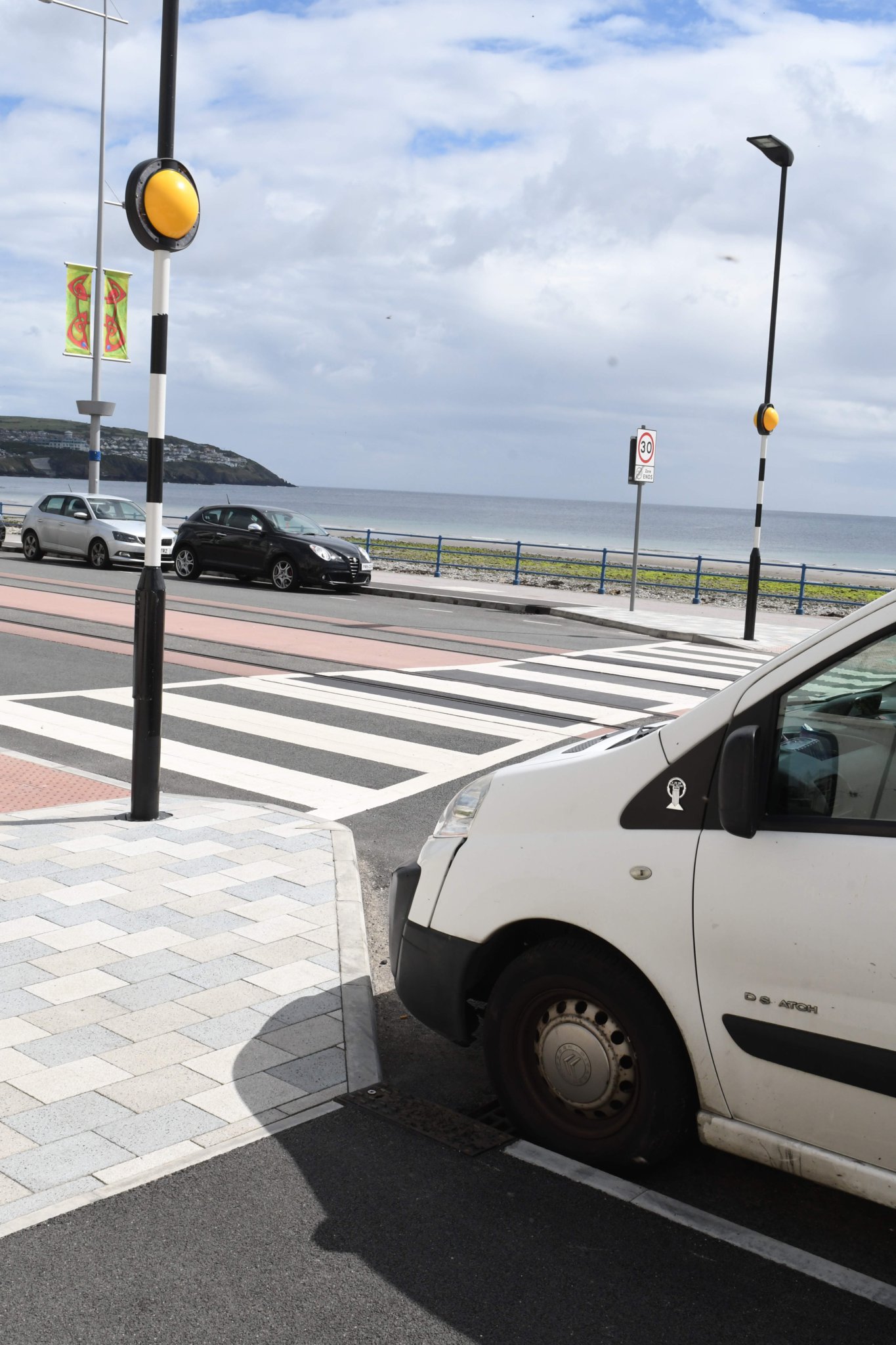 Parked cars adjoining a pedestrian crossing at the esplanade on Douglas Promenade -