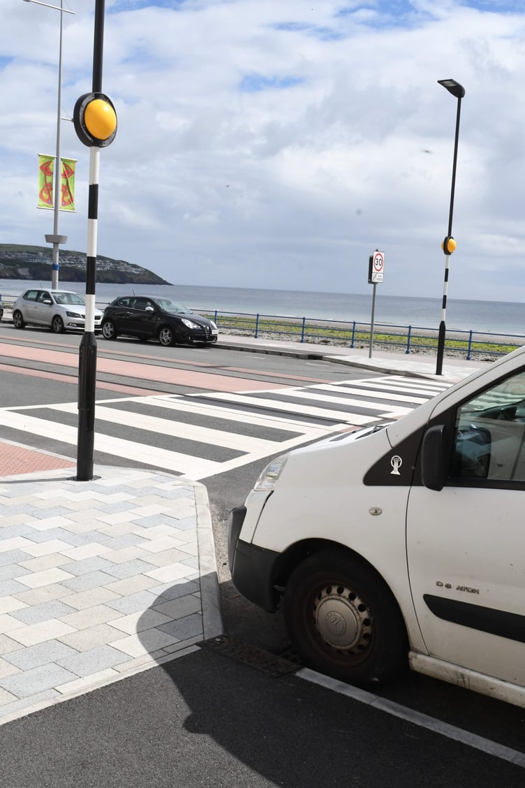 Parked cars adjoining a pedestrian crossing at the esplanade on Douglas Promenade -
