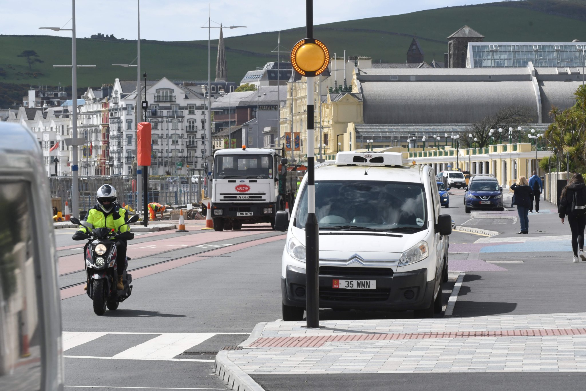 Parked cars adjoining a pedestrian crossing at the esplanade on Douglas Promenade -