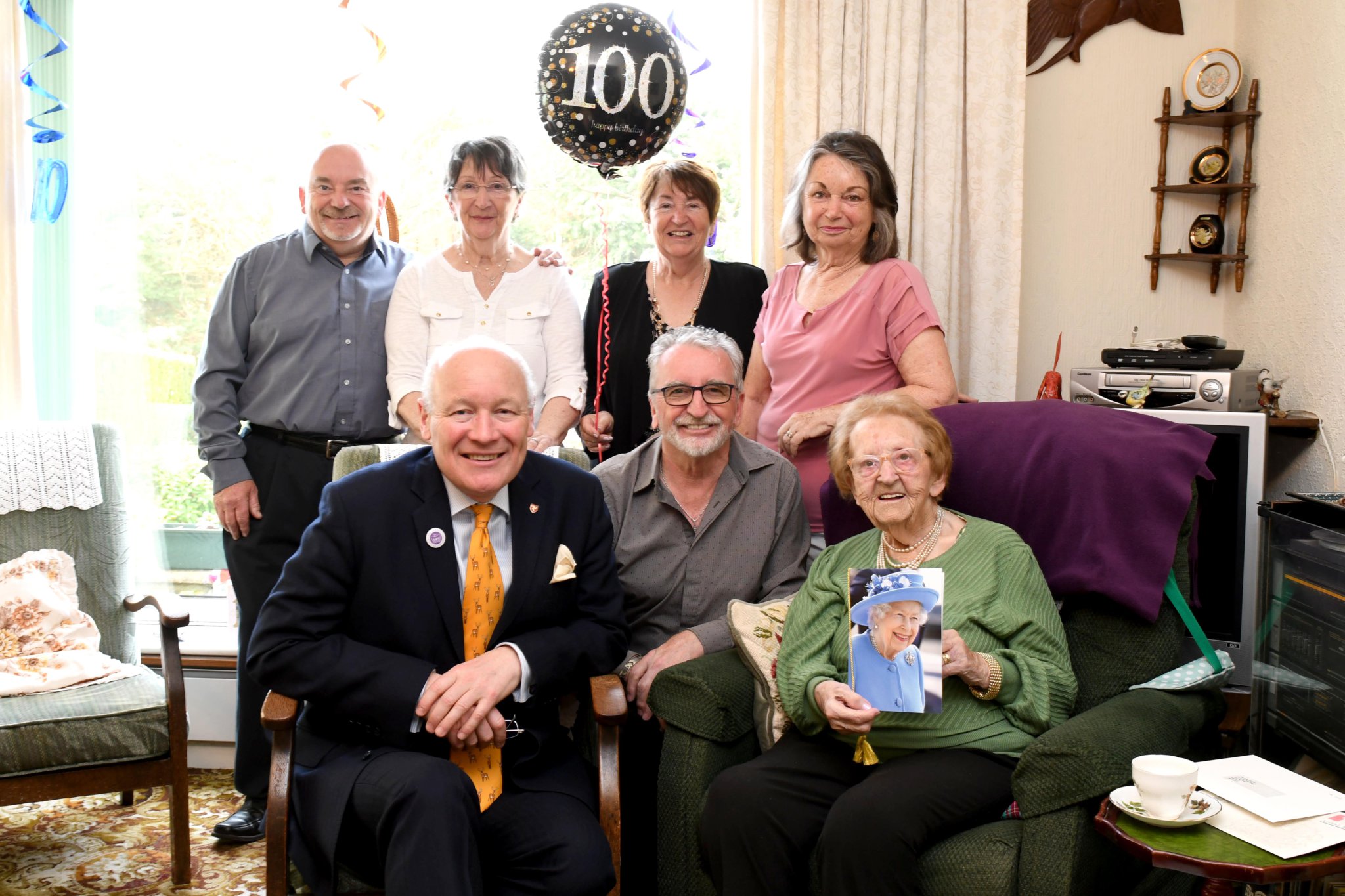 Mrs May Corlett celebrates her 100th birthday - back row, pictured left to right: David Corlett, Lin Maxfield, Cathy Cowell, Elaine Shepherd. Front row: Lieutenant Governor Sir John Lorimer, Graham Corlett and May Corlett