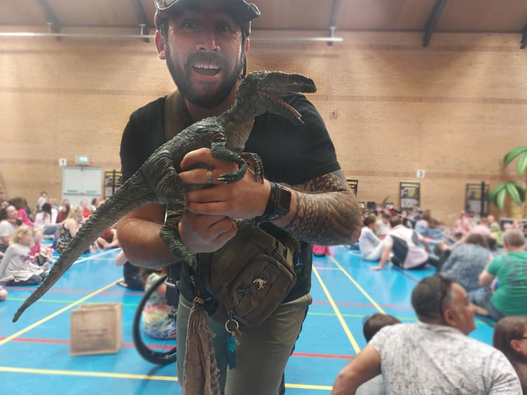 Head Ranger Chris with a baby raptor