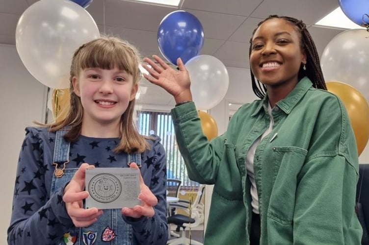Bethany Turner, from Alresford, with her winning satellite emblem design and Blue Peter presenter Mwaksy Mudenda