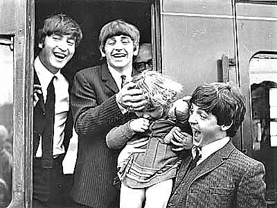 <p>Beatles - John, Ringo and Paul with a young fan as they disembark from a train</p>