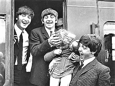 <p>Beatles - John, Ringo and Paul with a young fan as they disembark from a train</p>