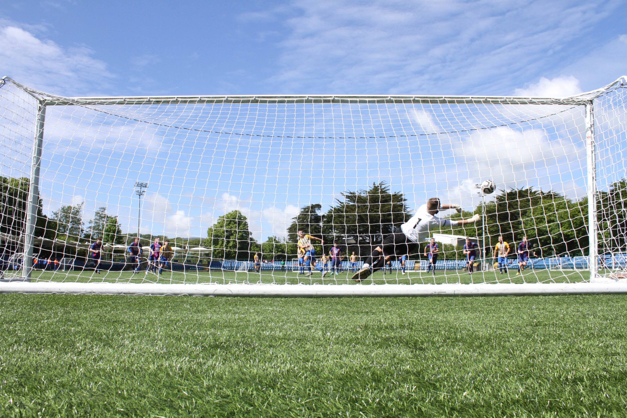 Foxdale keeper Andy Ball reacts brilliantly to save Dean Leece’s penalty during Saturday’s Gold Cup final (Photo: CS220528(8)/Cjs Photography)