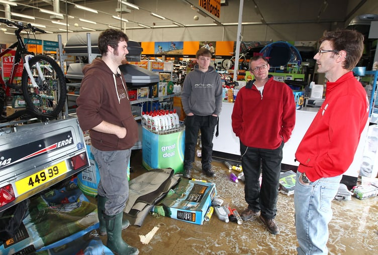 Staff at Halfords assess the damage