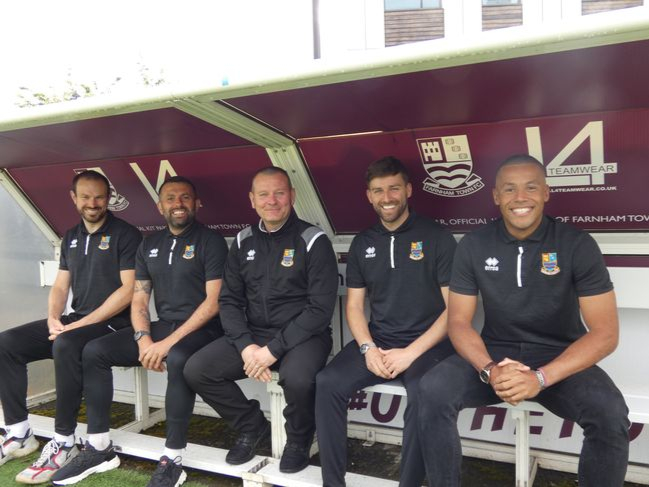 Sean Birchnall, centre, with the new faces in the Farnham Town dugout