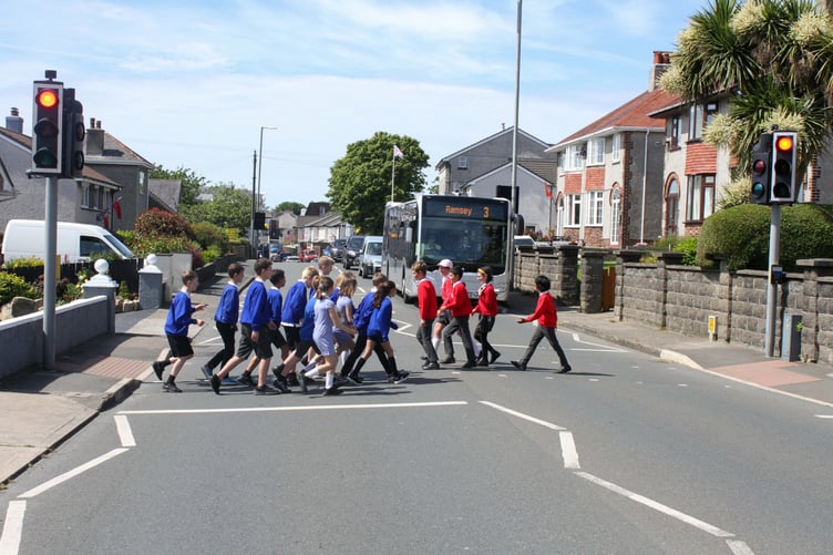 School children from both Ashley Hill Primary School & Onchan Primary School using the pelican crossing in Onchan. Photo by Callum Staley (CJS Photography).