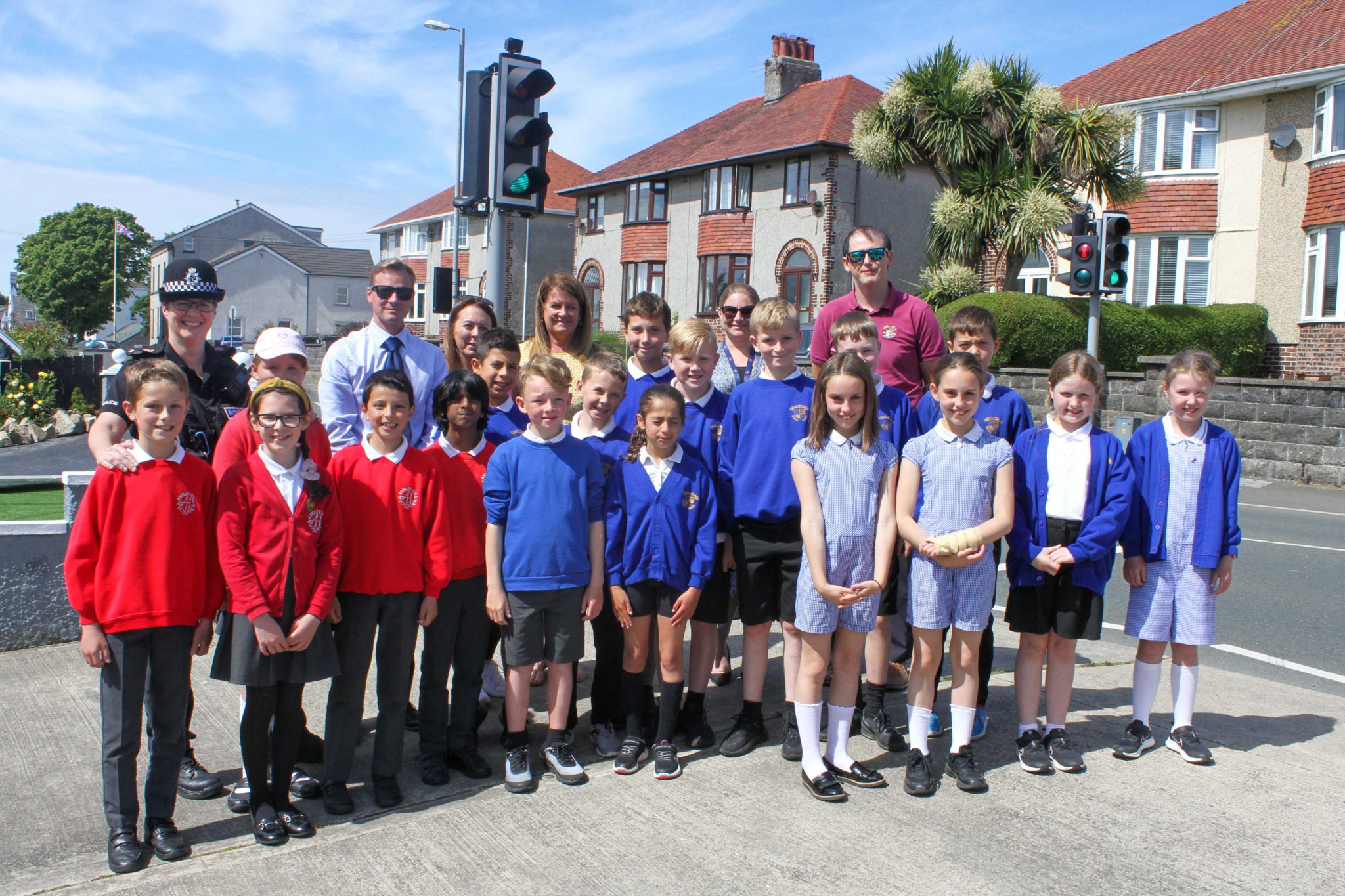 Police members, Onchan Commisioners, Parents, Ashley Hill Primary School children & Onchan Primary School children at the pelican crossing in Onchan. Photo by Callum Staley (CJS Photography).
