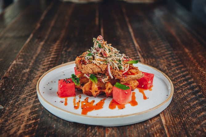 The Botanist’s buttermilk fried chicken waffle with maple sriracha, coleslaw and watermelon
