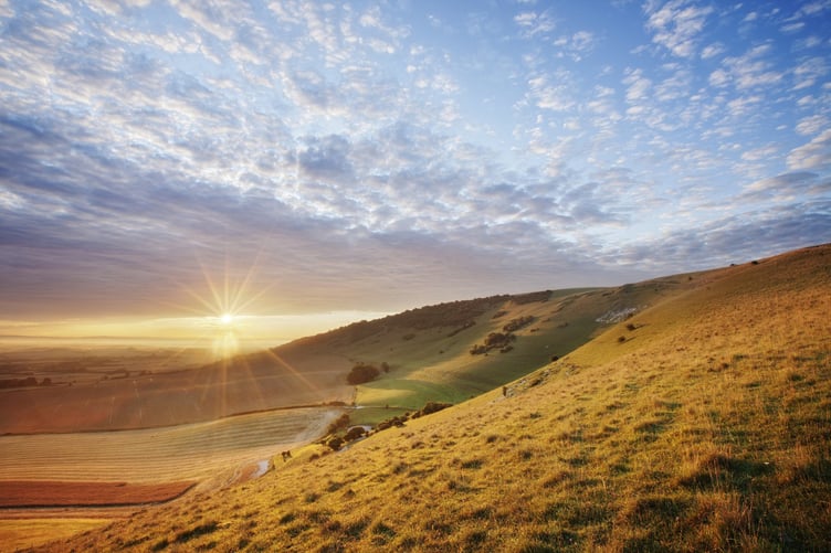 Sunrise over chalk downland viewed from Wilmington Hill, Willmington, South Downs National Park, East Sussex, England, UK