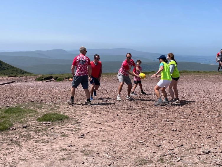 The group playing on top of Pen y Fan