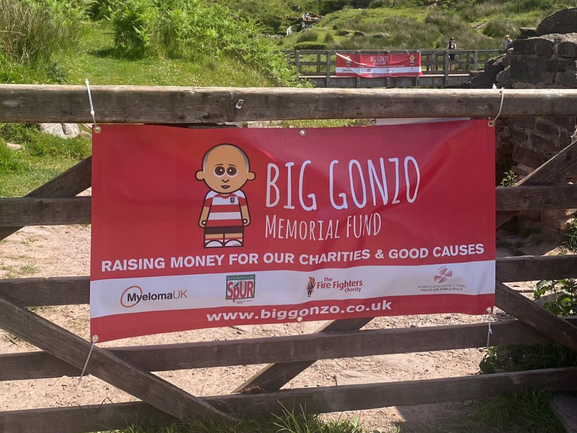 A banner on a gate leading up Pen y Fan