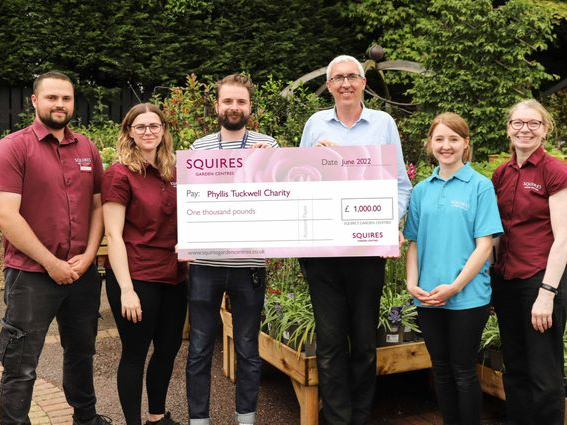 Assistant centre manager Chris Price presents Tom Enser with a cheque for £1,000