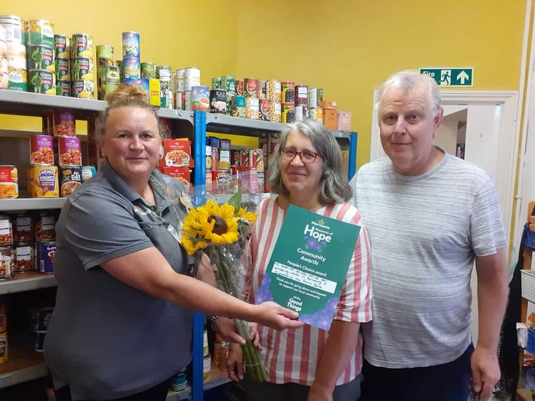 Mandy, left, presenting a Community Hero Award to Steve Gill and his wife.