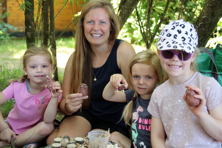 Becca Hernendez of Stoke Climsland school is pictured with local children making clay owls in the school forest. Picture: Paul Hamlyn
