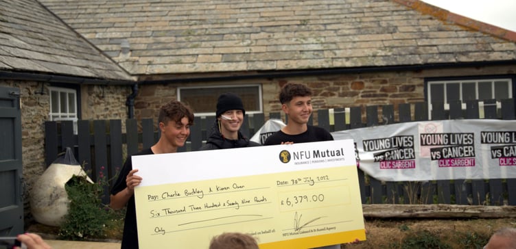 BARNEY (centre) Charlie and Kieran with the cheque for £6379 from NFU Mutual