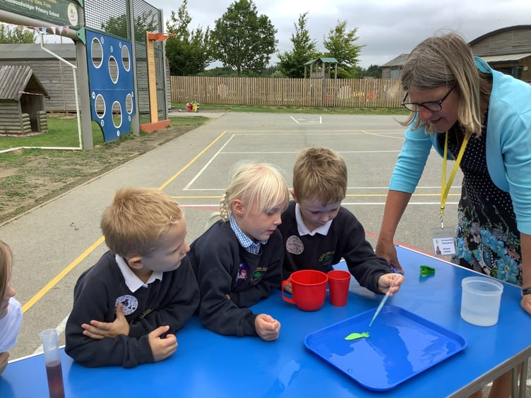 Dr Cooper, Mr Piper and Mr Adams from Launceston College finding out about Reception children’s work on density