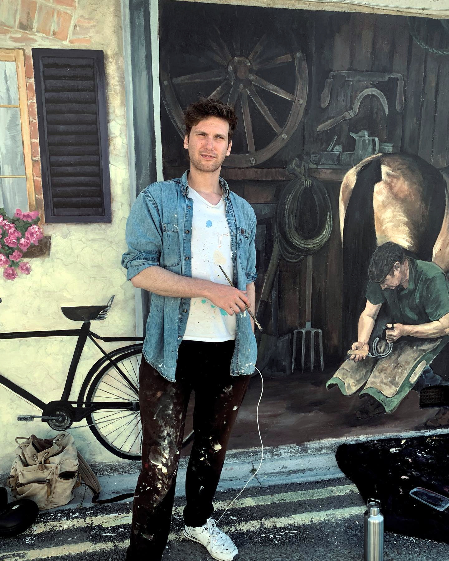 Manny Pearce (above) was commissioned to bring new life to this beloved mural (right)