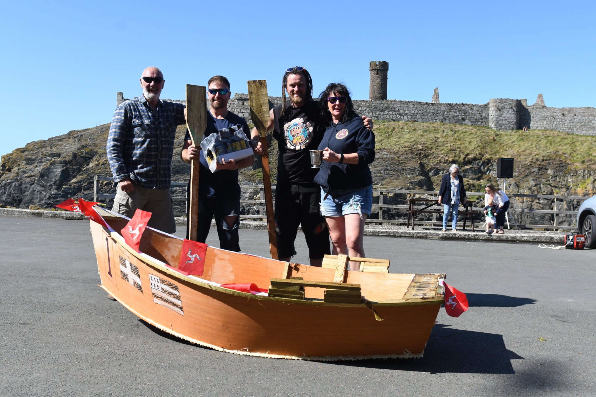 The build-a-boat competition and race at Fenella beach, part of the 2022 Peel Traditional Boat Festival - the Yn Chruinnaght team, winners of the race and the design prize