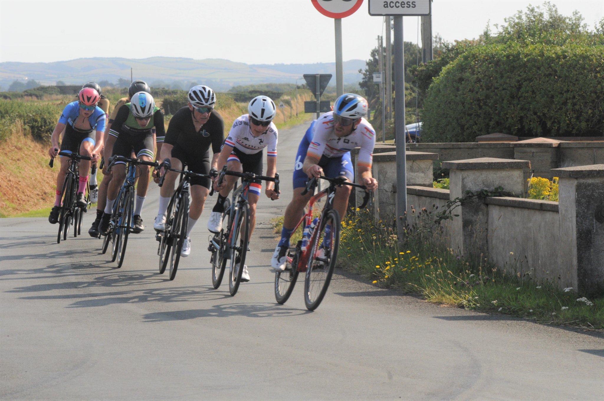 The pivotal point in Sunday’s Fred Kelly Memorial Road Race when Team TotalEnergies pro-rider Chris Lawless got across to the lead group, giving it the impetus it needed to stay away from a similarly strong chase group. Behind him at the former Jurby Filling Station are eventual winner Zac Walker, Rob Moneta, Will Curphey, Tyler Annis, Oscar Gaylor (pink helmet) and Niall Colquitt (Photo: John Watterson)