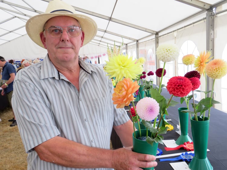 Roger Hutchings from South Brent with his prizewinning flowers. He won eight first prizes for his blooms with his pride and joy being his mixed dahlias
