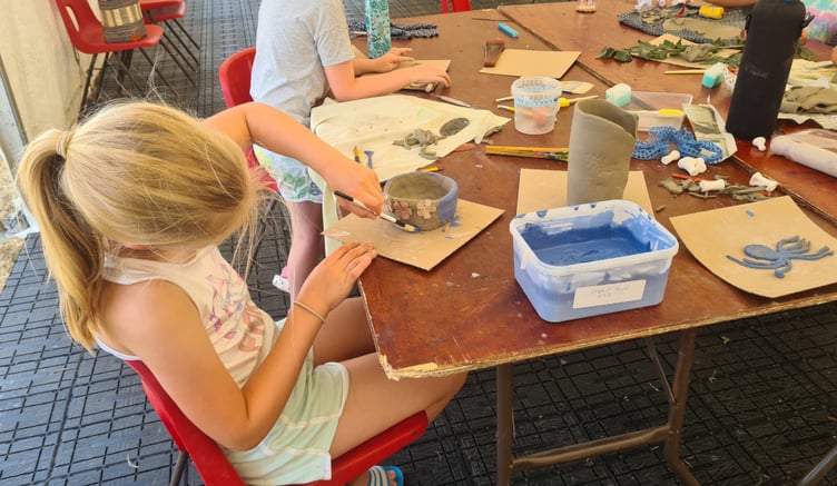 Hand building and decorating pots.