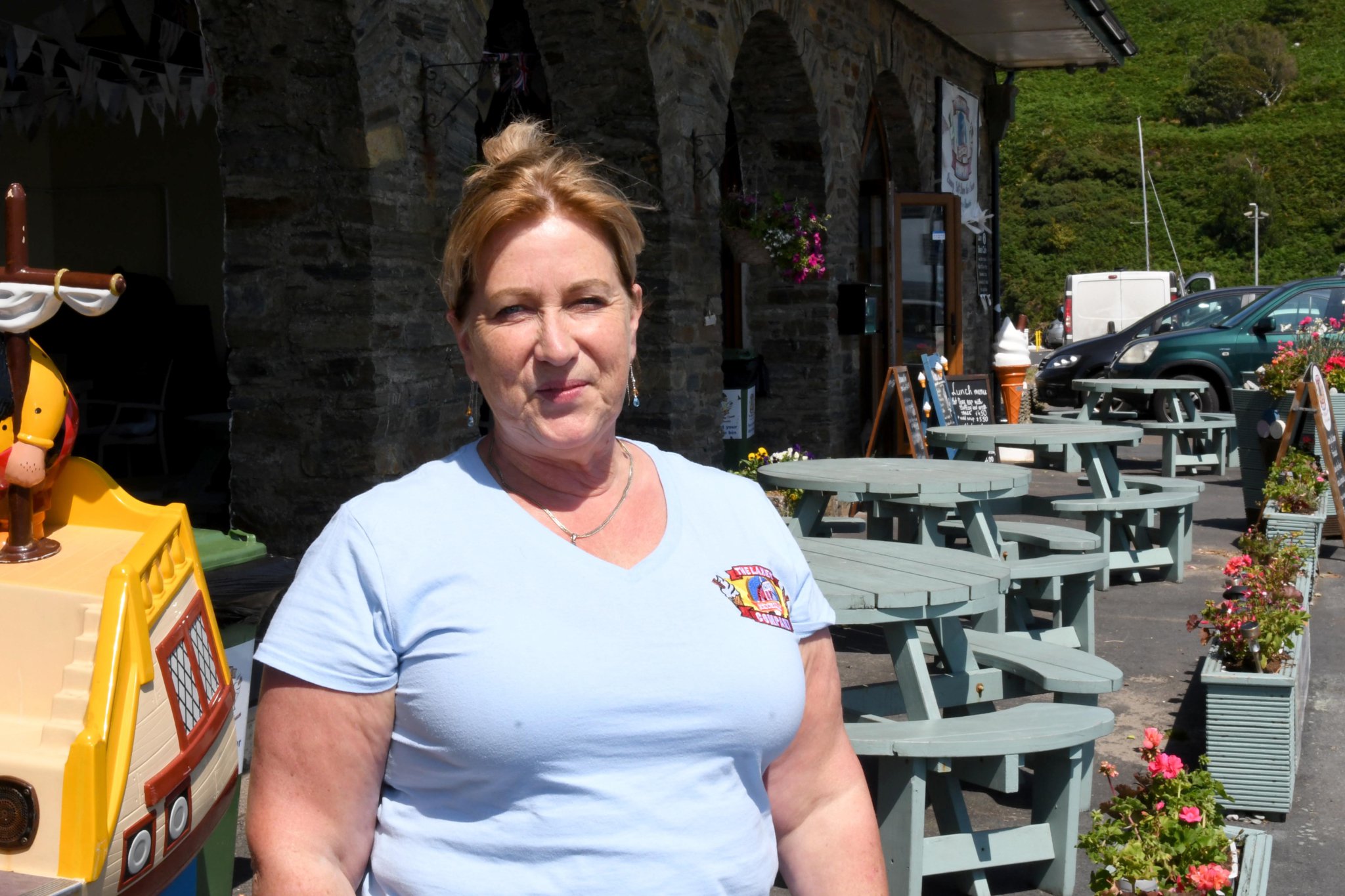 The Laxey Beach Cafe and the public shelters on Laxey Promenade - pictured is proprietor Julie Pinson