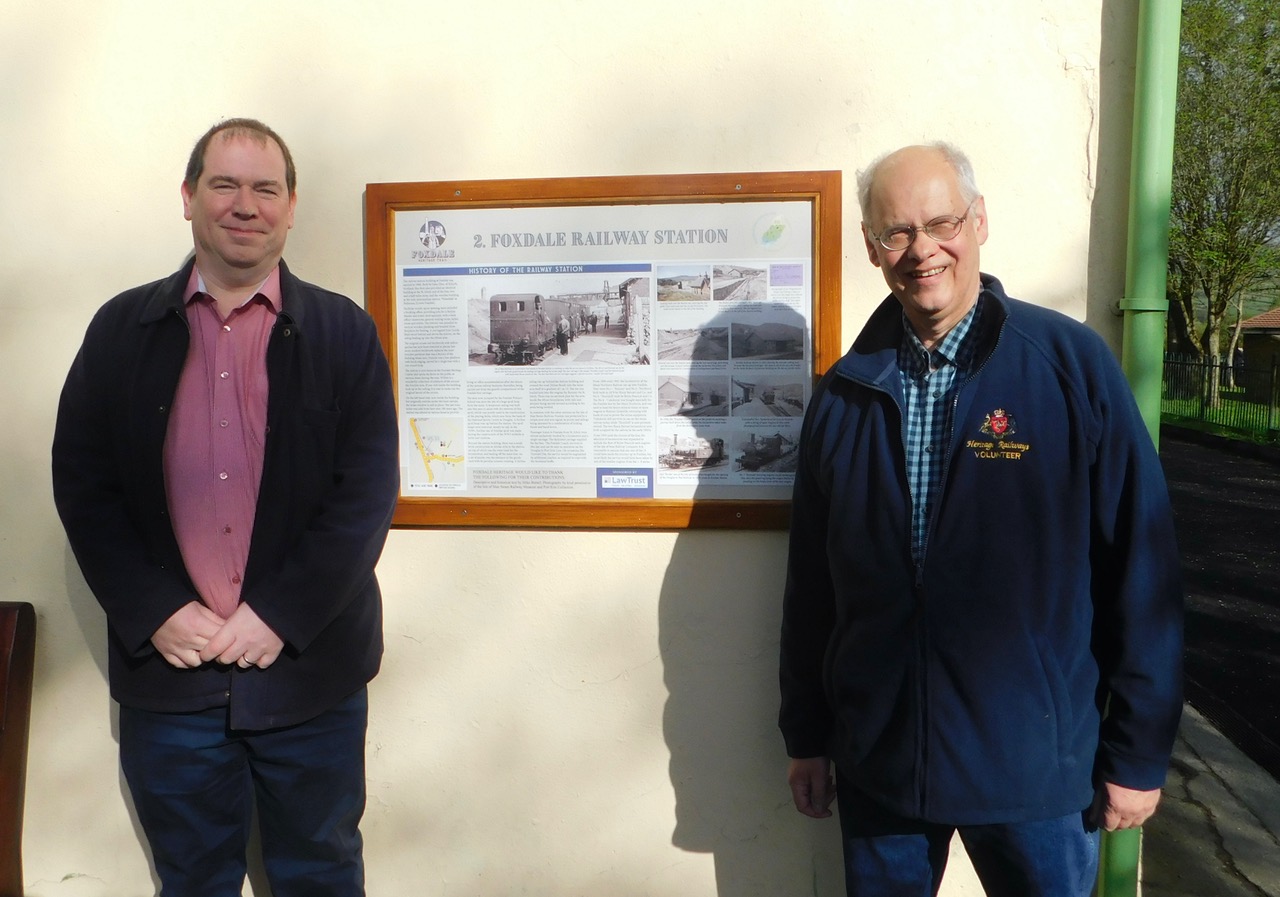 Tony Keating of Law Trust Ltd, a sponsor of the project, and Mike Buttell, the author of boards two, three and four, next to board two of the Foxdale Heritage project