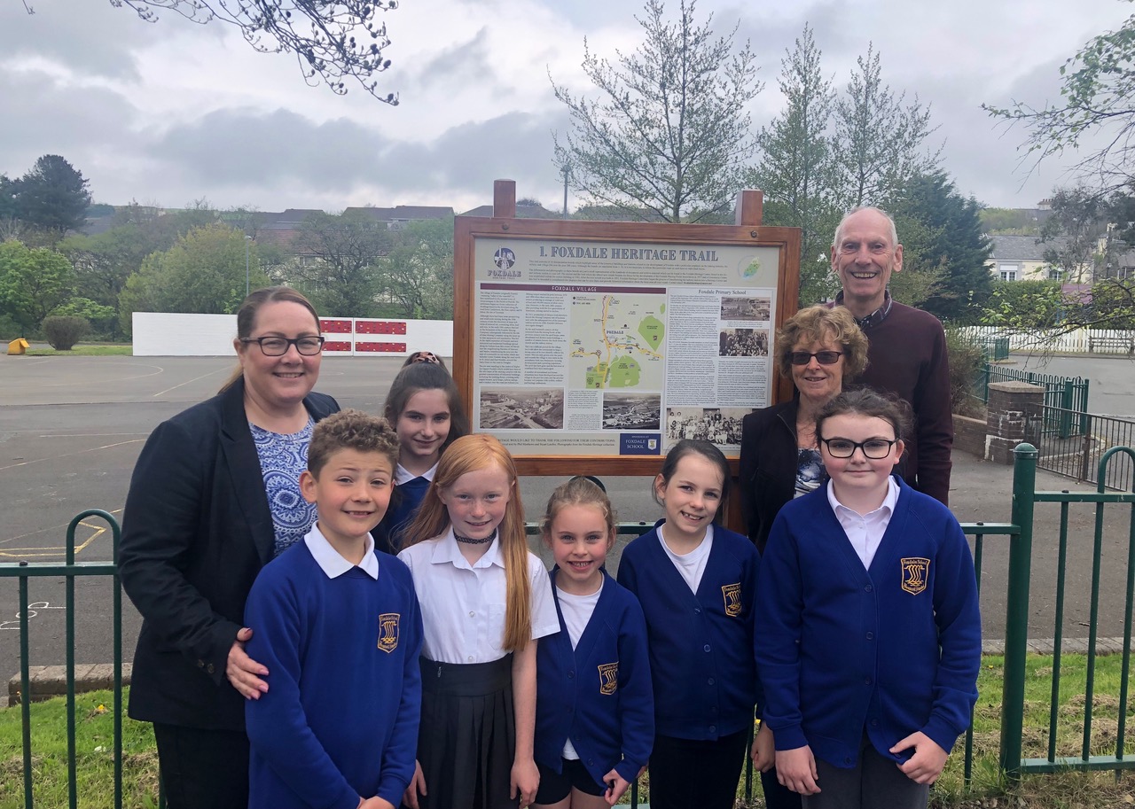 L-R, Anna Griffiths, Headteacher of Foxdale Primary School, children from the school, Ann Jessop, a former headteacher and trustee of Foxdale Heritage, and Stuart Lambie, trustee and secretary for the charity and another former headteacher