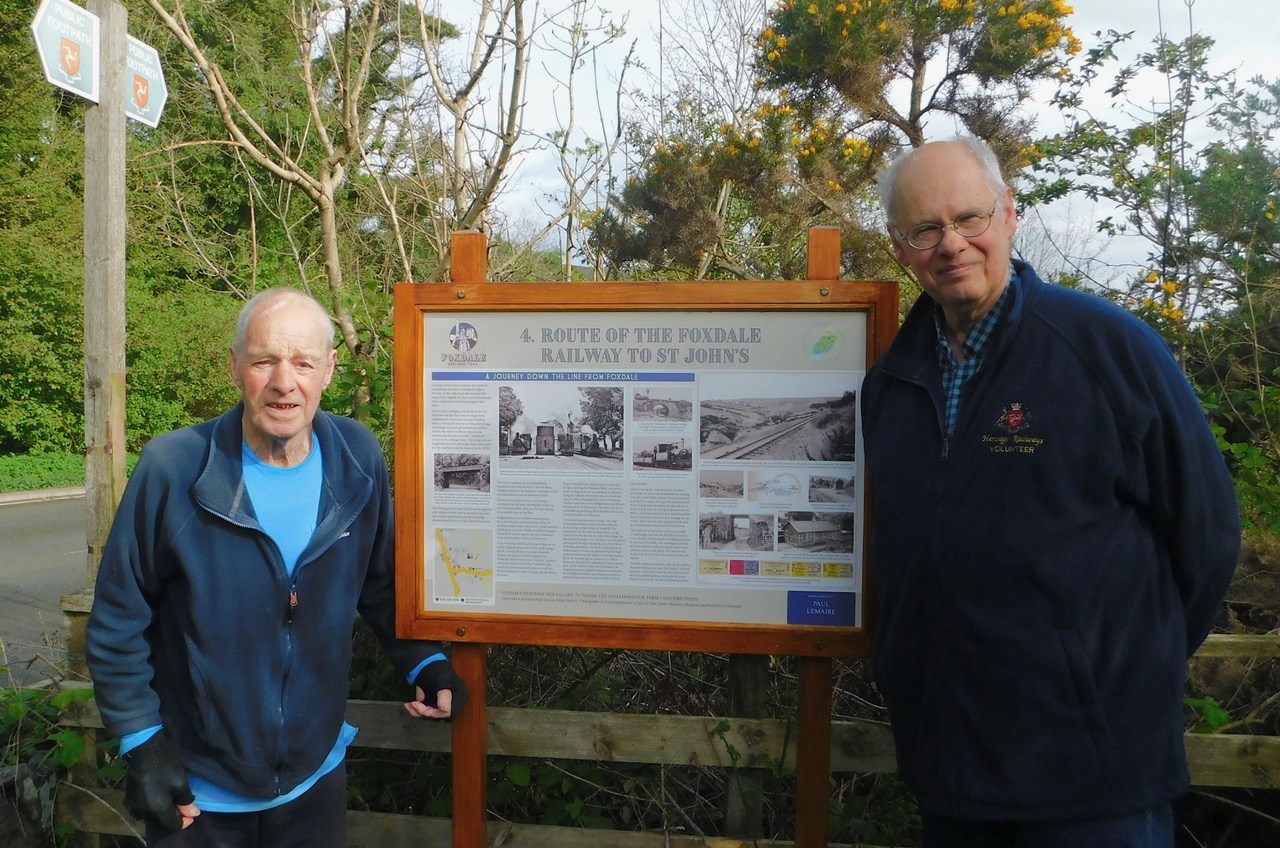 Paul Lemaire, chairman and founder of Foxdale Heritage, and Mike Buttell, the author of multiple interpretation boards, next to board four
