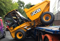 Close call as JCB knocked off trailer at Wrecclesham railway bridge