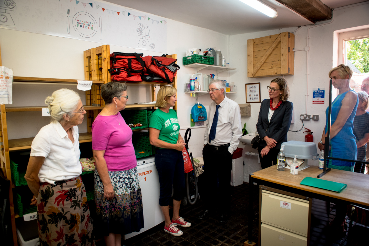 First Minister Mark Drakeford visits Monmouth Community Fridge behind the orange door at the Stables in Bridges where he heard how donated food is distributed freely