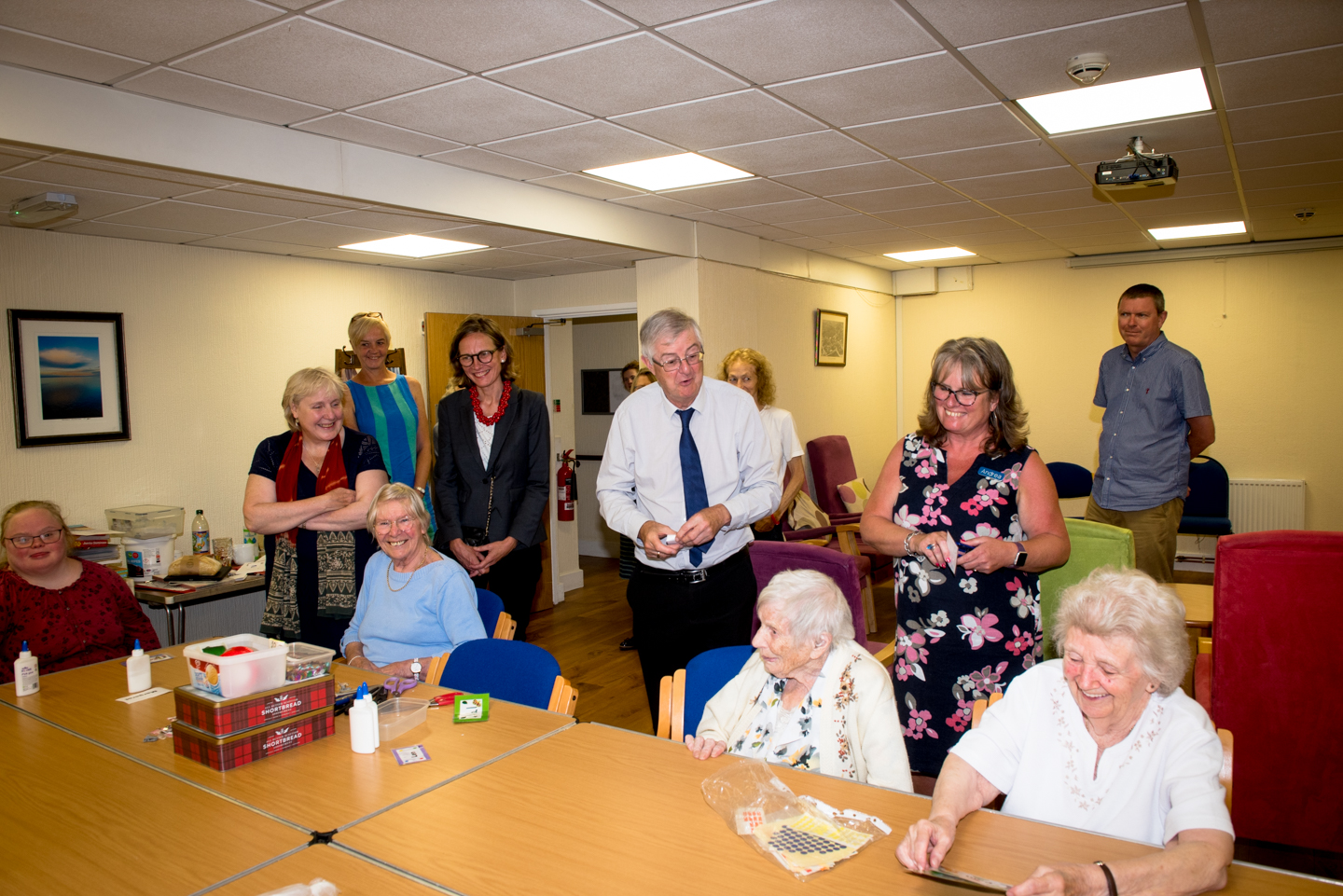 First Minister Mark Drakeford visits Monmouth Community Fridge behind the orange door at the Stables in Bridges where he heard how donated food is distributed freely