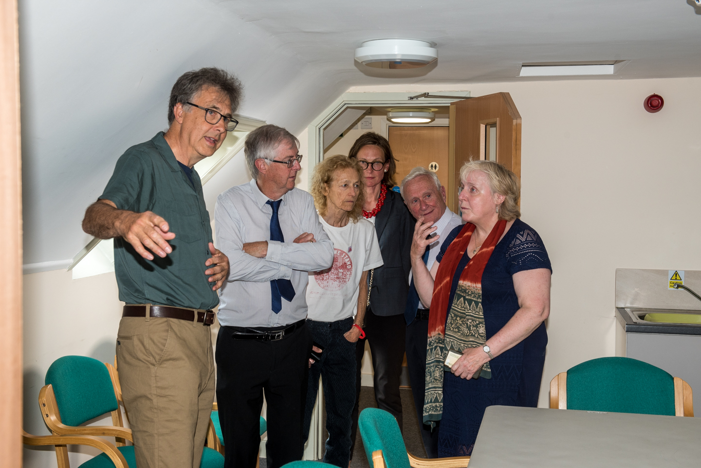 First Minister Mark Drakeford visits Monmouth Community Fridge behind the orange door at the Stables in Bridges where he heard how donated food is distributed freely