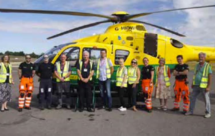 Lindford fete organising committee members meet Hampshire and Isle of Wight Air Ambulance staff at Thruxton airfield, September 2022.