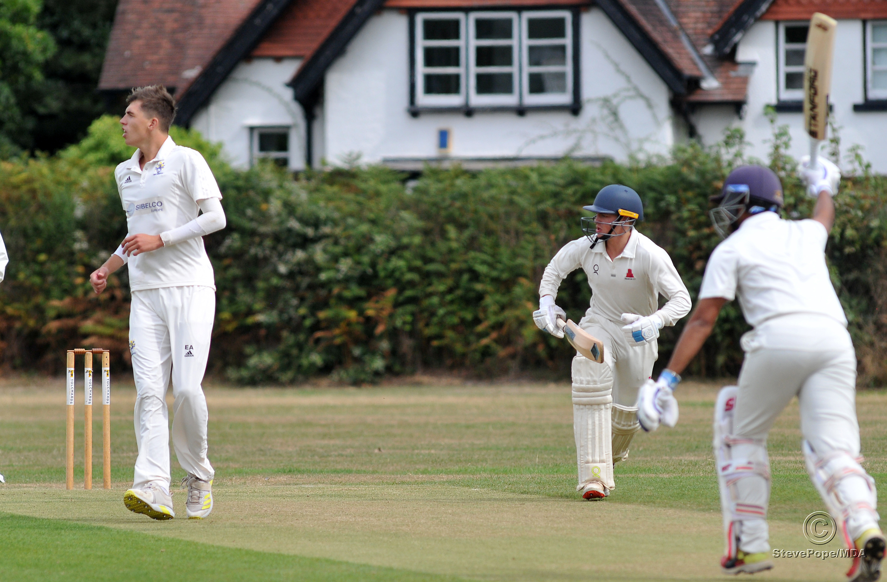 Photo: Steve Pope MDA030922G_SP005 Tolchards Devon Cricket League Premier Division. Bovey Tracey versus Paignton. Bovey's Elliott Adams watches as Paignton's Divyaansh Saxena and Ollie Woodcock start building up the runs