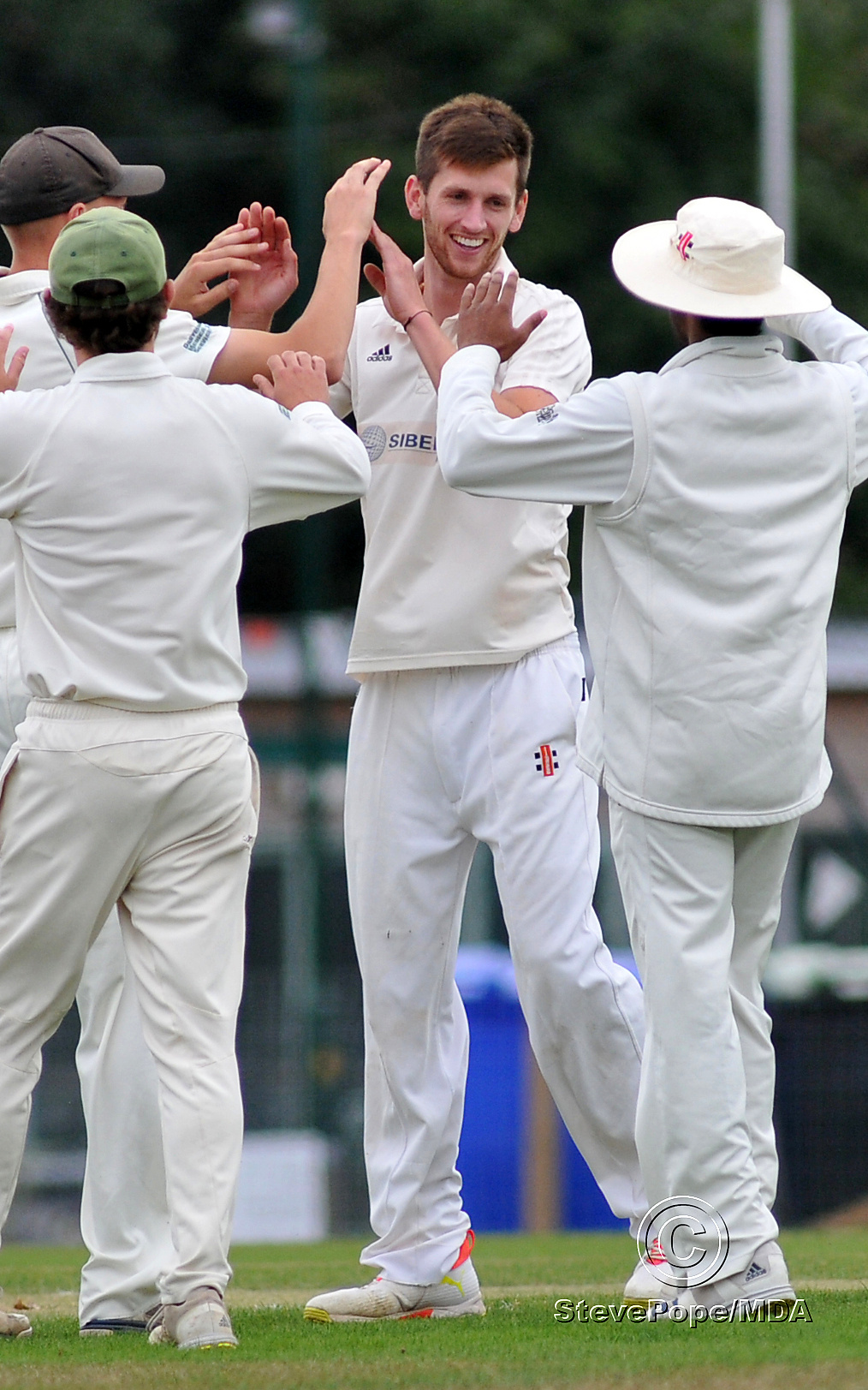 Photo: Steve PopeMDA030922G_SP007 Tolchards Devon Cricket League Premier Division. Bovey Tracey versus Paignton. High fives all round for Bovey's bowler Seb Ansley after dismissing Paignton's Harry Ward.