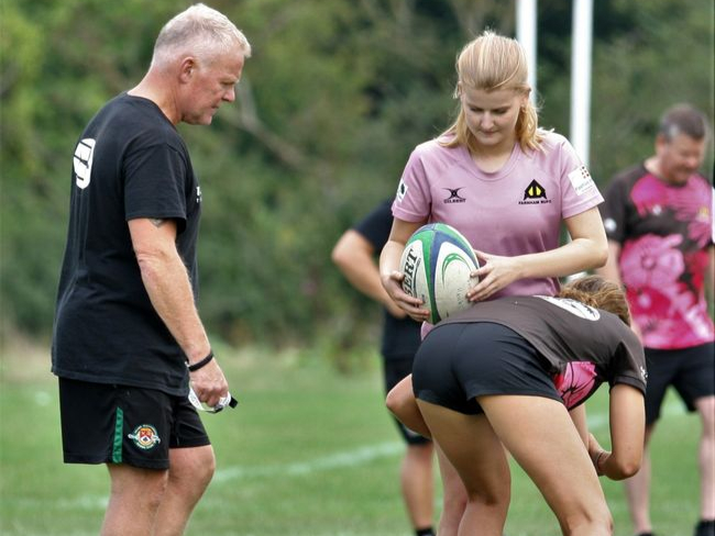 Farnham Rugby girls hone their tackling skills under the watchful eye of Ealing Trailfinder’s head of rugby Steve Wagstaff