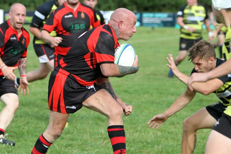 ABOVE: Chris Watts crashes over for a try. ABOVE RIGHT: Liam Mills with a strong carry. BELOW: Ollie Tape with a strong run. BELOW LEFT: Twos captain James Lovering with some fancy footwork.