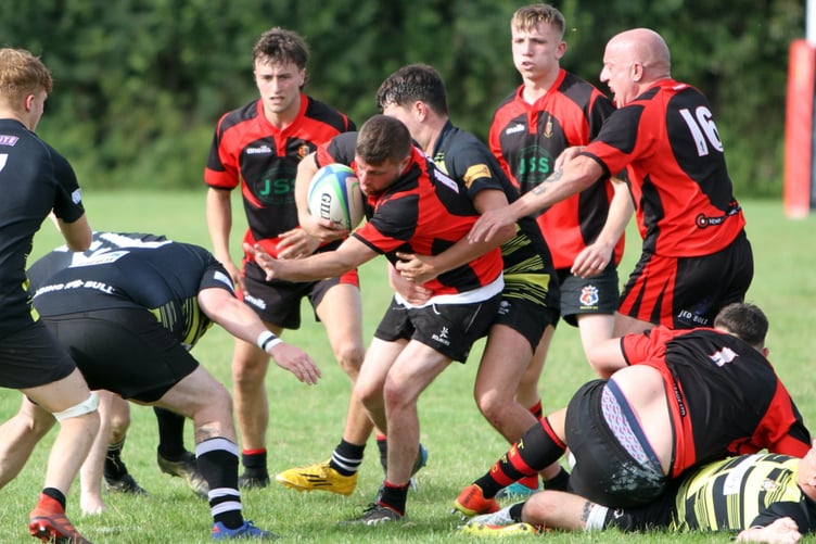 ABOVE: Chris Watts crashes over for a try. ABOVE RIGHT: Liam Mills with a strong carry. BELOW: Ollie Tape with a strong run. BELOW LEFT: Twos captain James Lovering with some fancy footwork.